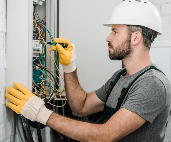 side-view-of-handsome-bearded-electrician-repairin-resize-pyzlpgdjenir7l7pyfa5n64n33vby8a9nm3f6ejonc